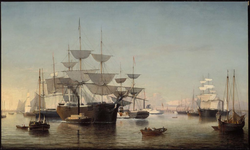 view of busy harbor full of sailing ships and steamships